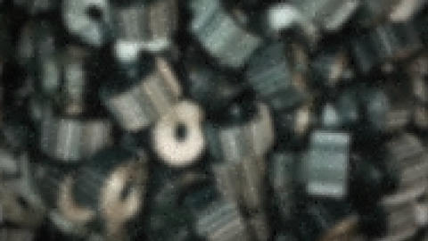 Blured mechanical gears with track name an artis shown in the bottom left corner. WHole picture, including logo and title, are pixelized.